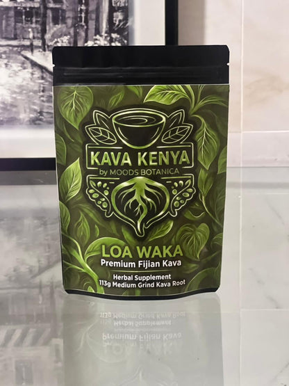 Kava Kenya Loa Waka packaging on a reflective surface with a blurred background